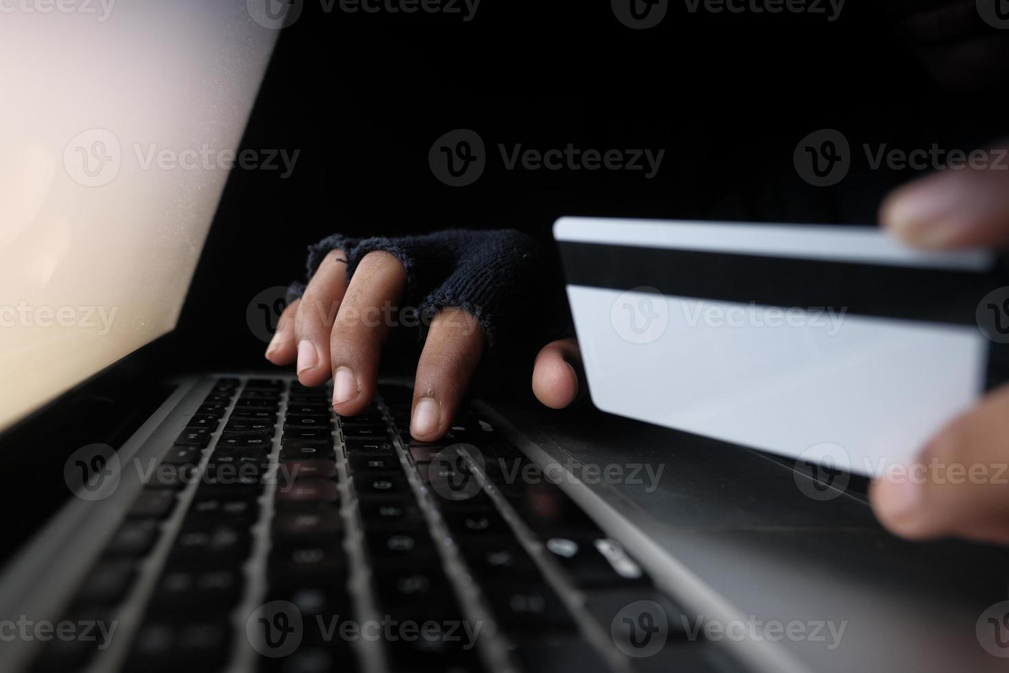 Hacker hand stealing data from credit card photo