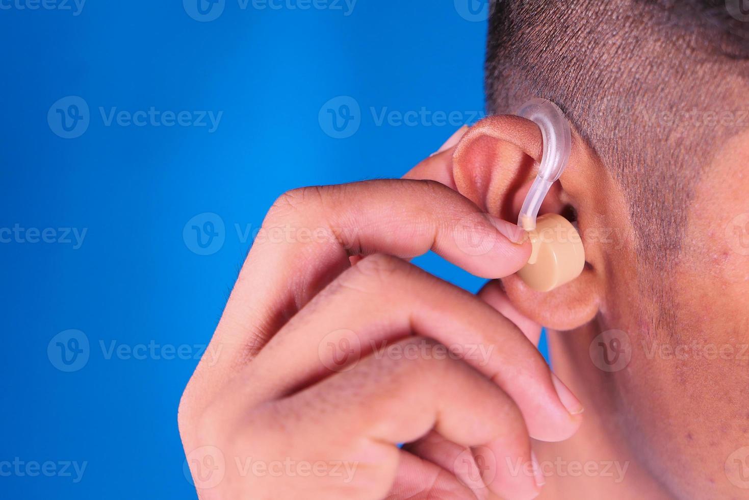 Hearing aid concept on blue background photo