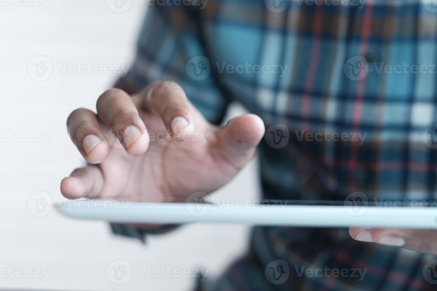 Man's hand working with a digital tablet photo