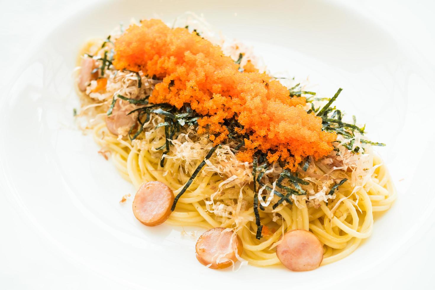espaguetis con chorizo, huevo de camarón, algas, calamares secos por encima foto