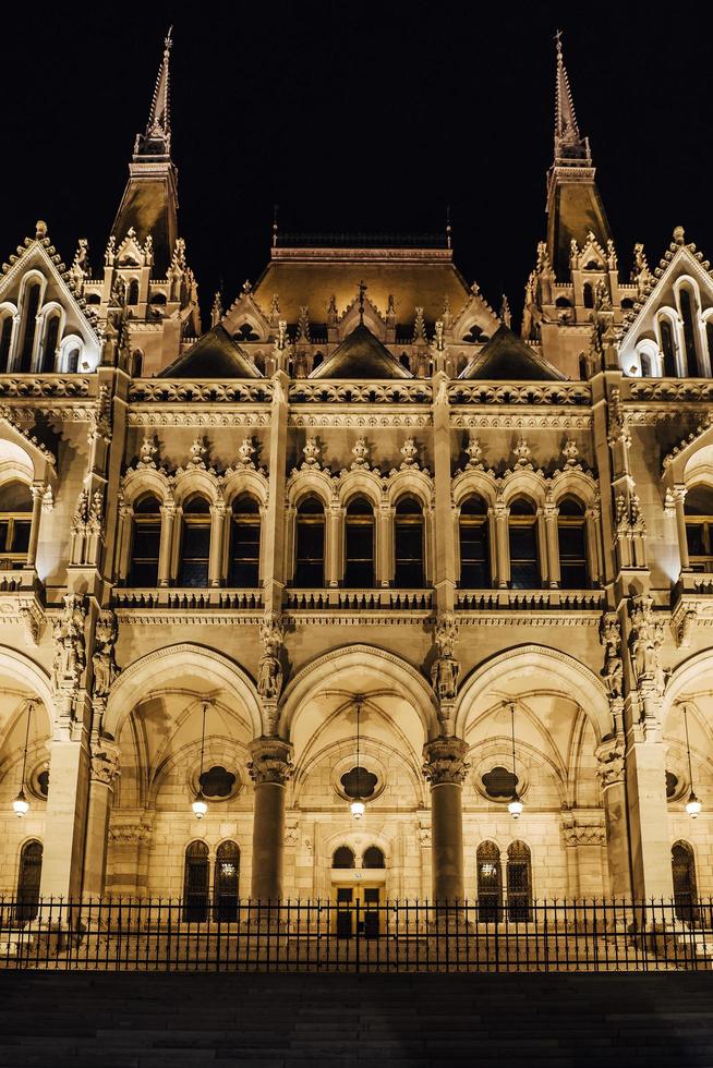 The Hungarian Parliament in Budapest on the Danube in the night lights of the street lamps photo