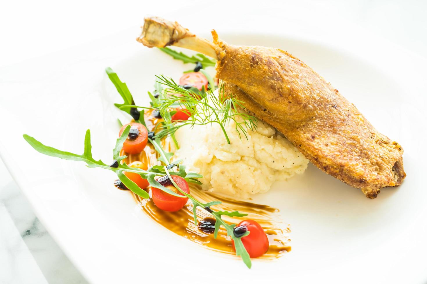 Fried duck leg with potato salad photo