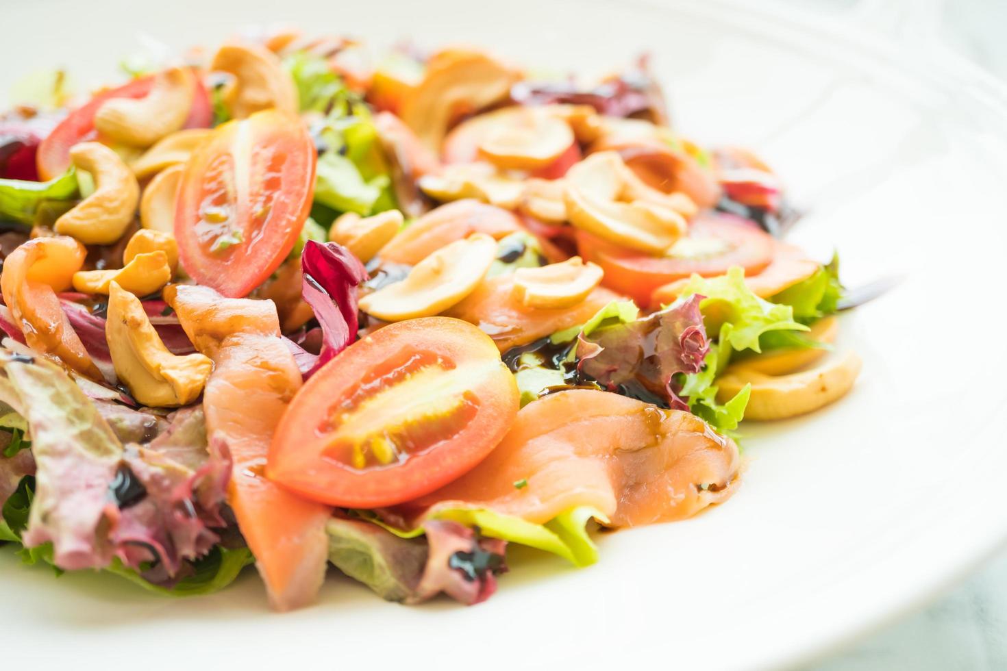 Tomato and vegetable salad with smoked salmon meat photo