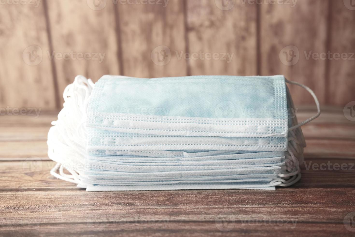 Stack of blue surgical masks on table photo