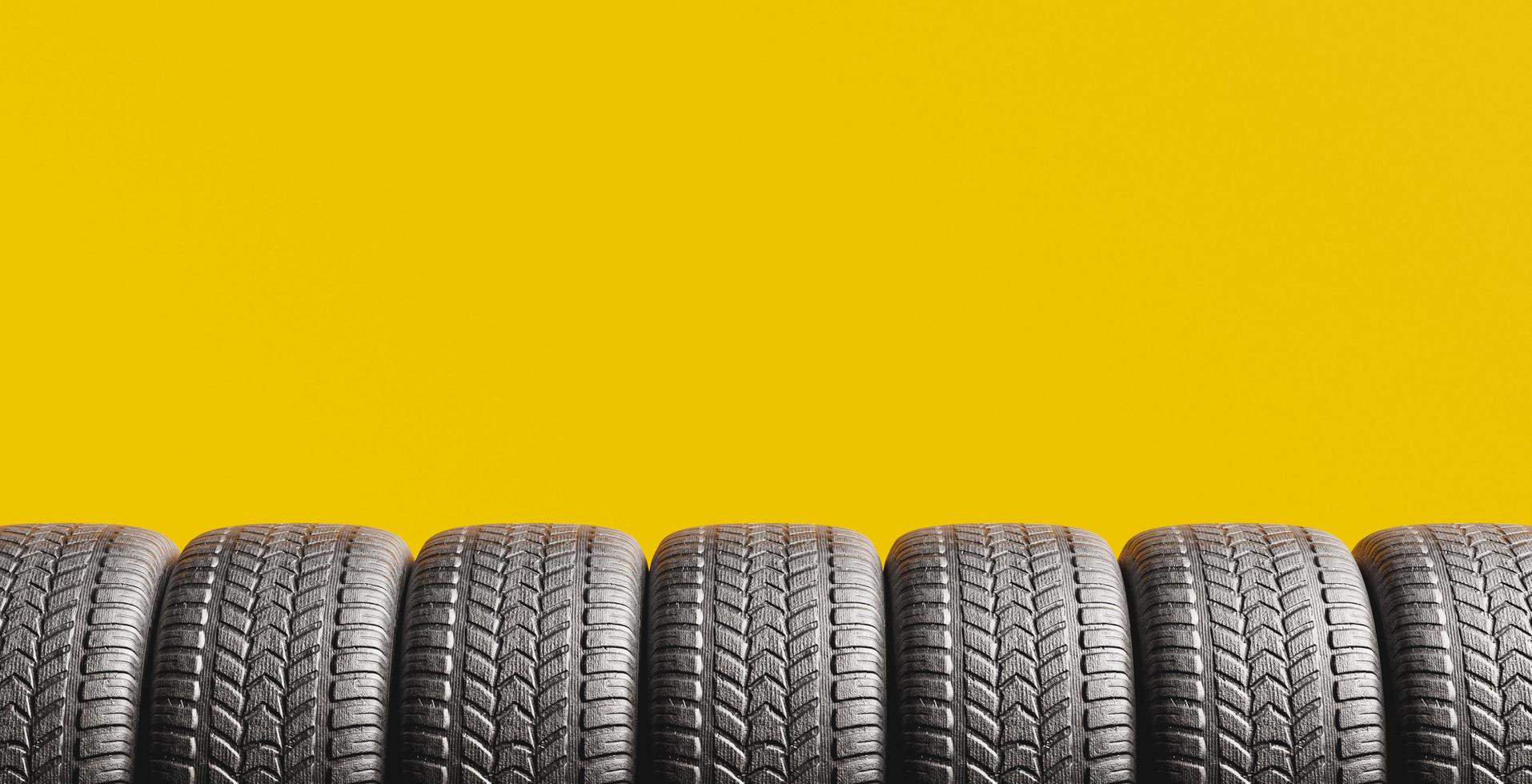 Yellow background with a row of tires photo