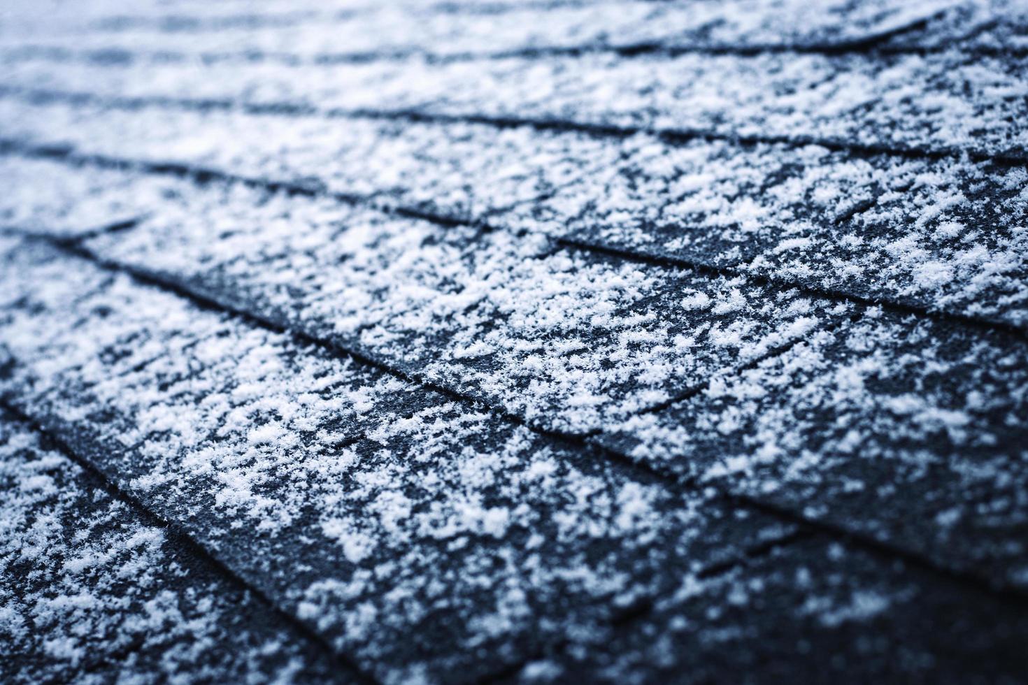 Snow on asphalt shingles photo