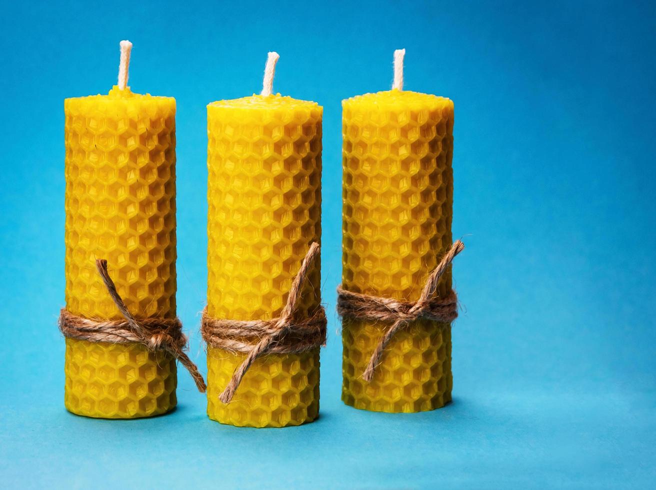 Beeswax candles on blue photo