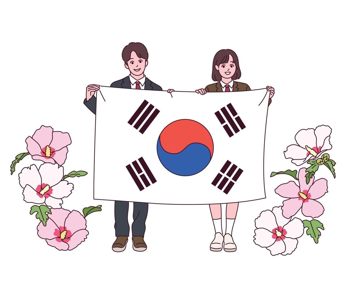 un joven estudiante y una estudiante están de pie con una gran bandera coreana. Las flores de Sharon están floreciendo a su lado. vector