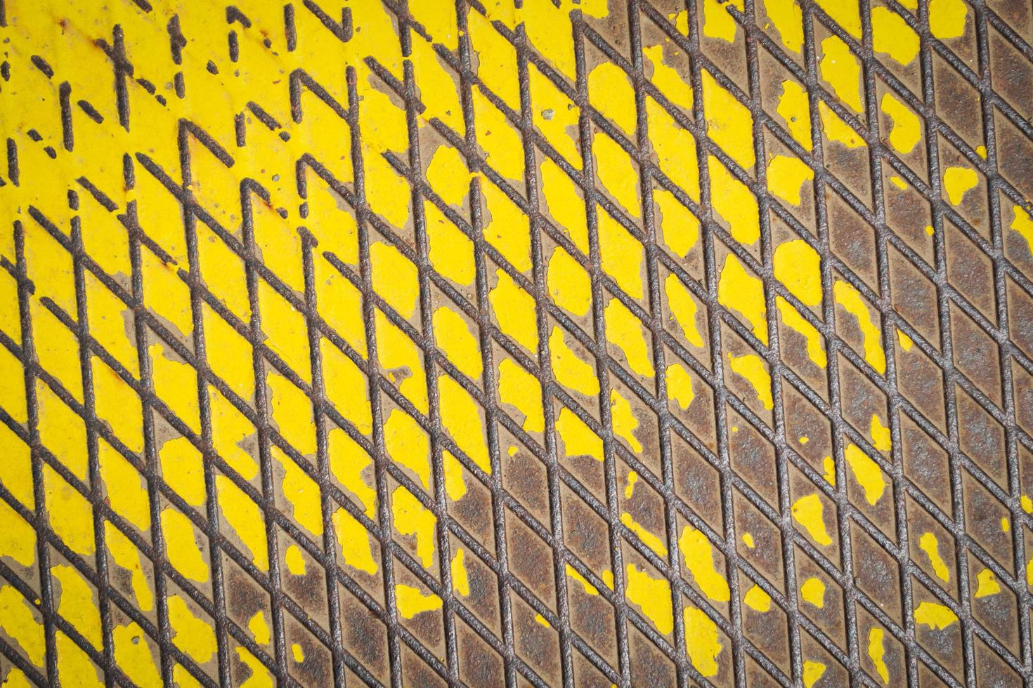 Old metal floor with yellow paint photo