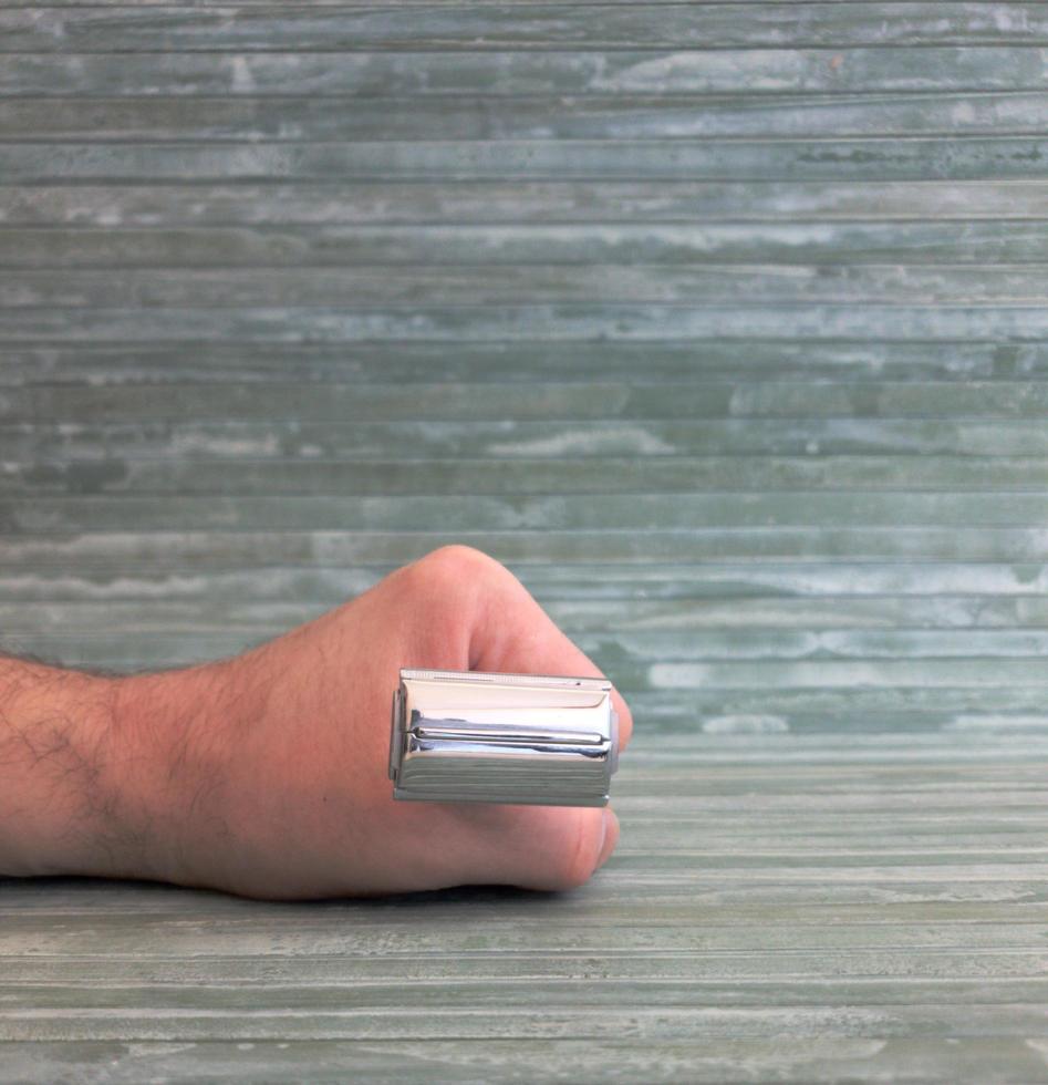 Holding a safety razor in one hand photo