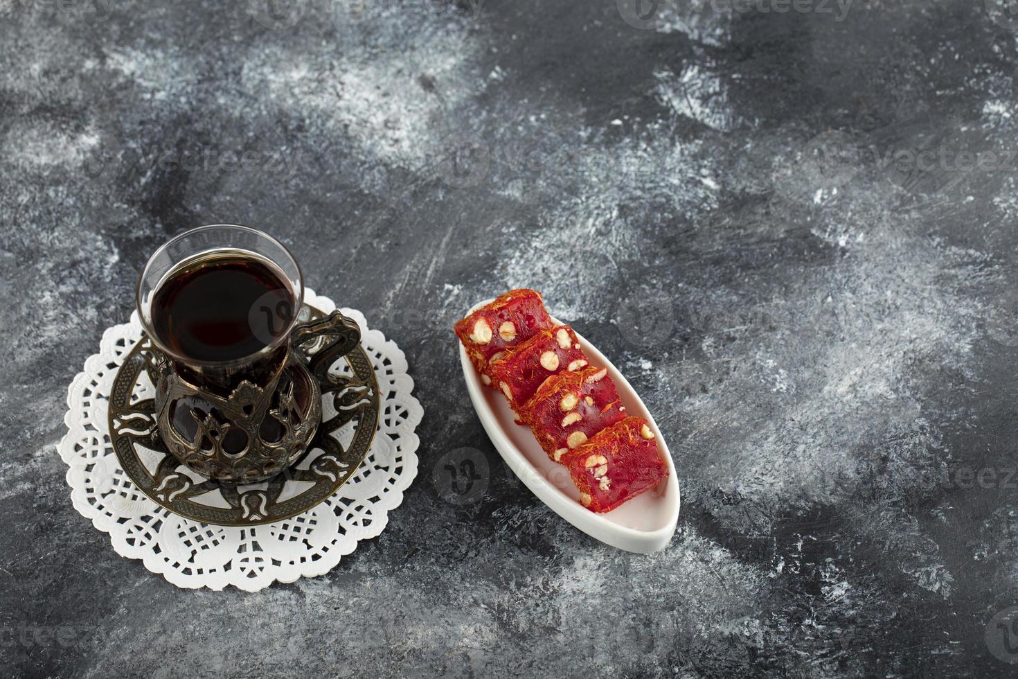 Tasty Turkish delight with a cup of hot tea photo