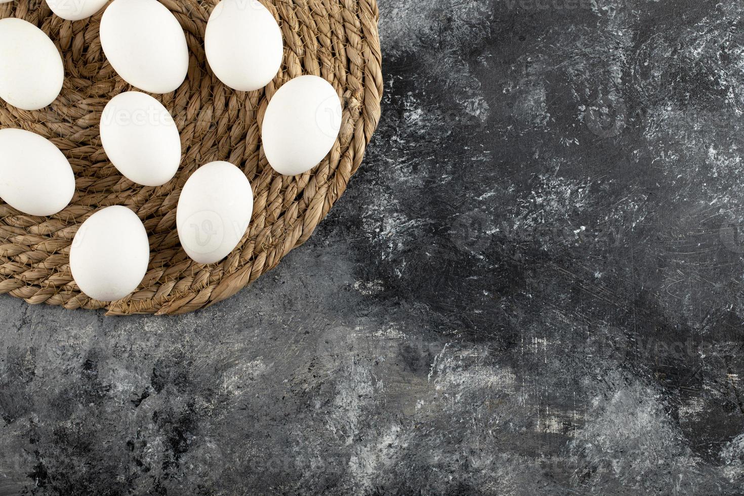 White raw chicken eggs on a sackcloth photo