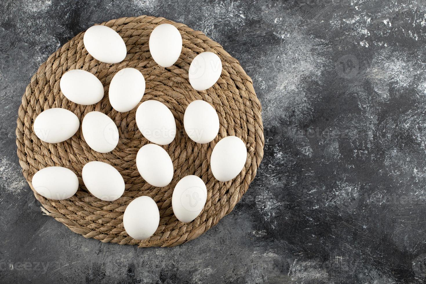 White raw chicken eggs on a sackcloth photo