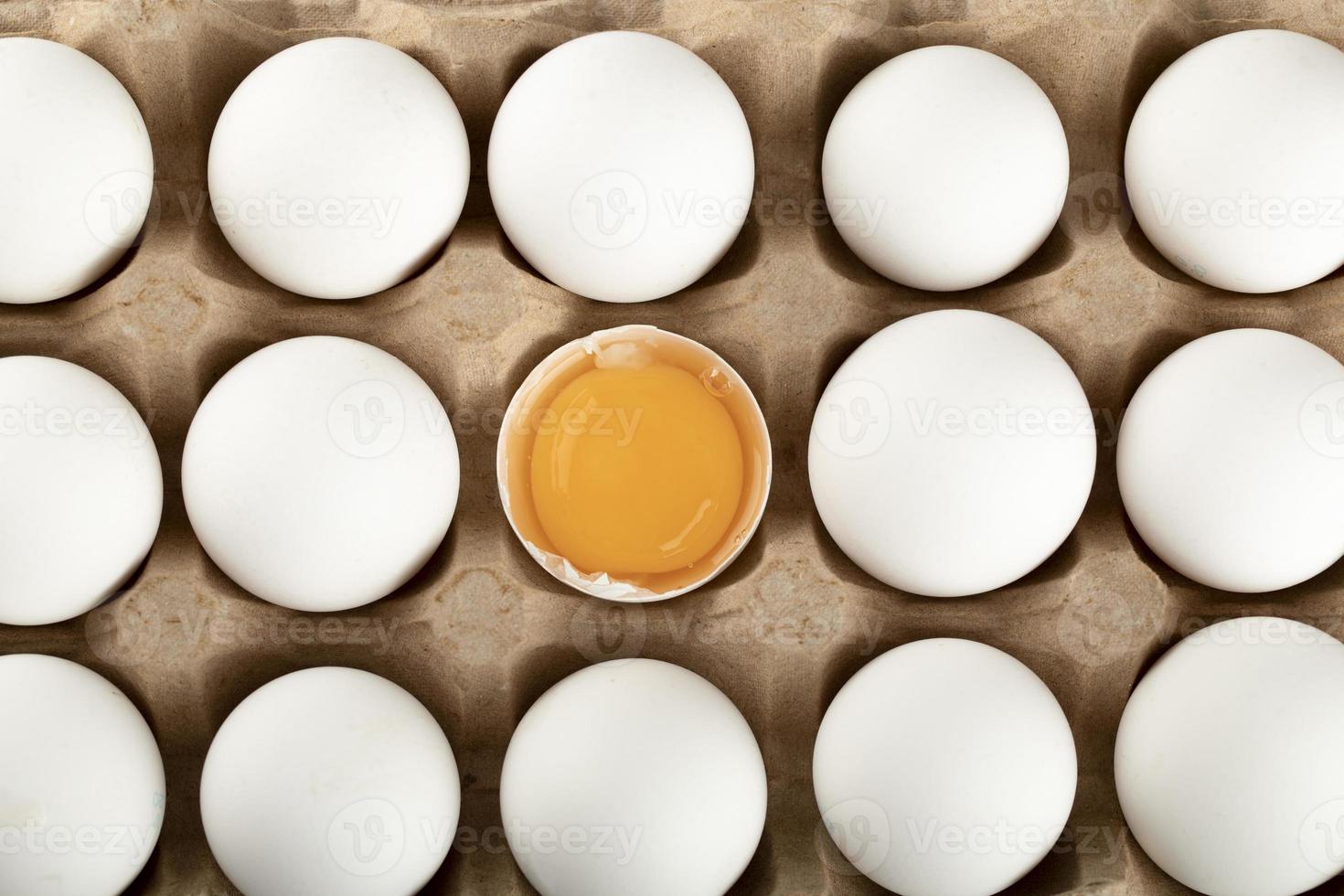 Raw chicken eggs in a carton container photo