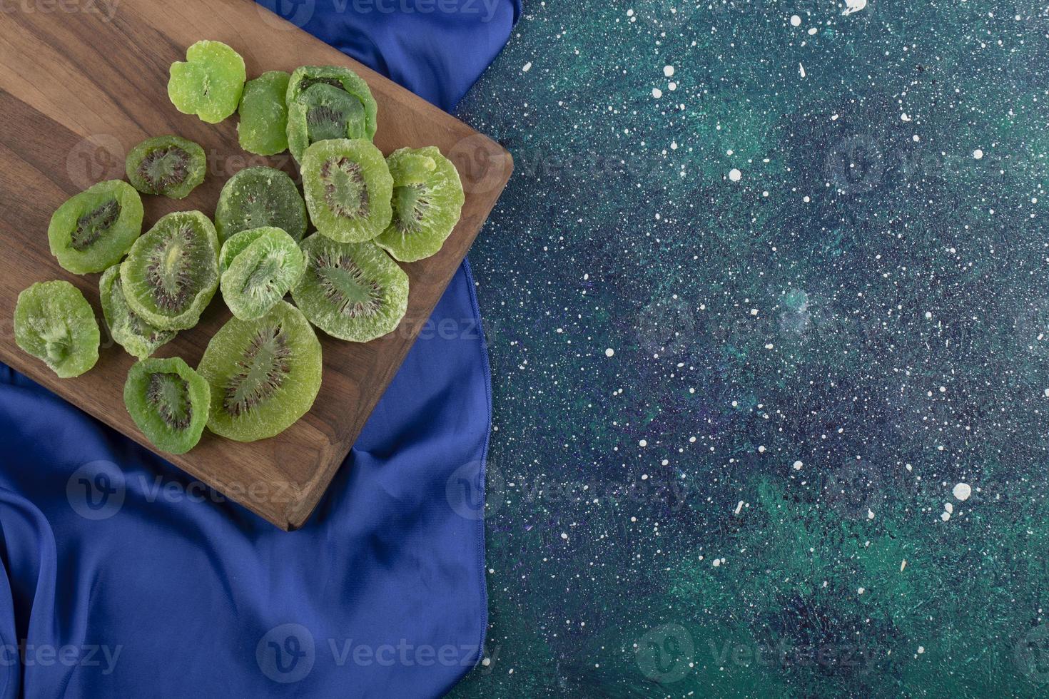 Dried slices of kiwi on a wooden board photo