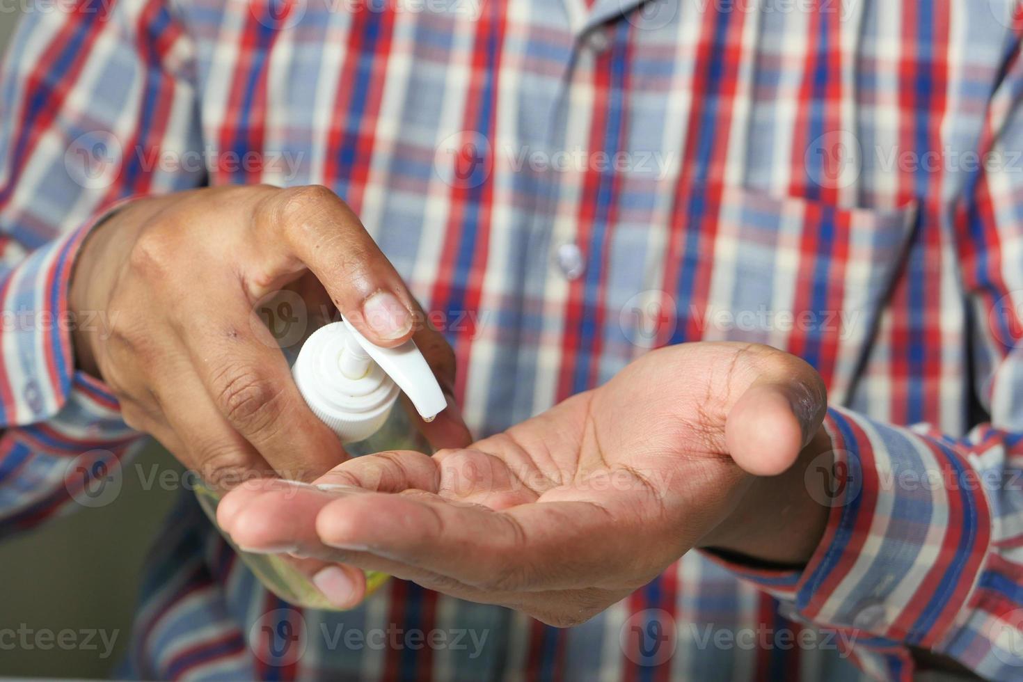 Close up of person using hand sanitizer photo