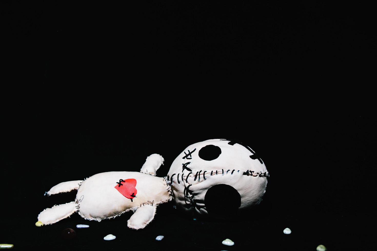 Voodoo doll on a black background photo