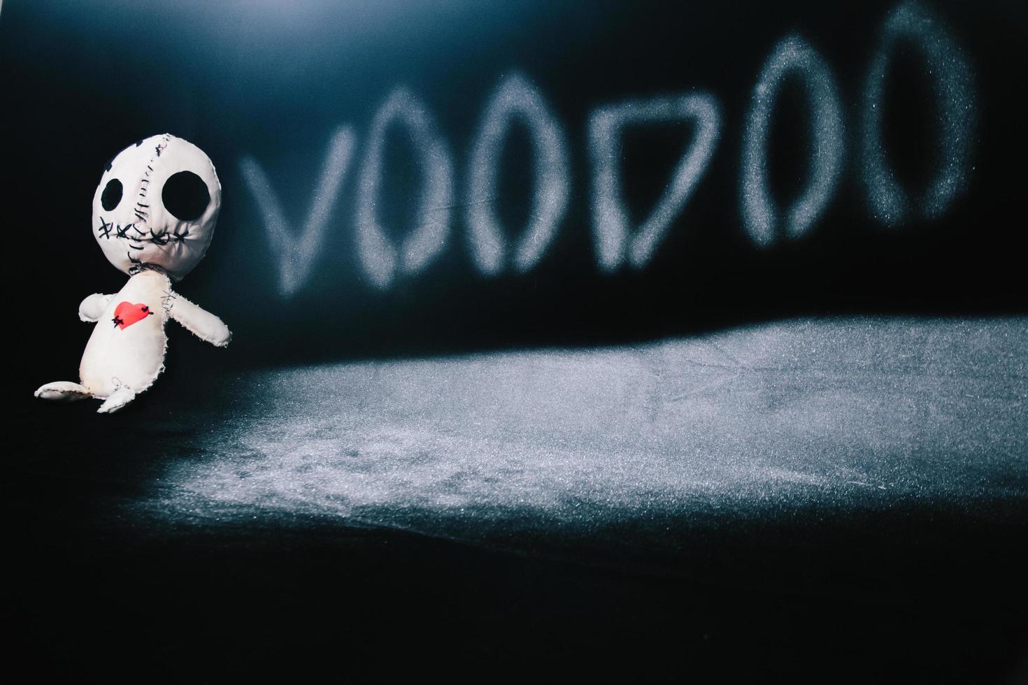 Voodoo doll on a black background photo