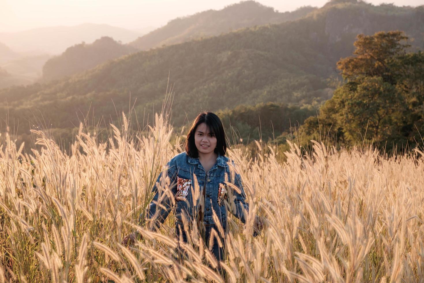 Woman walking in tall grass photo