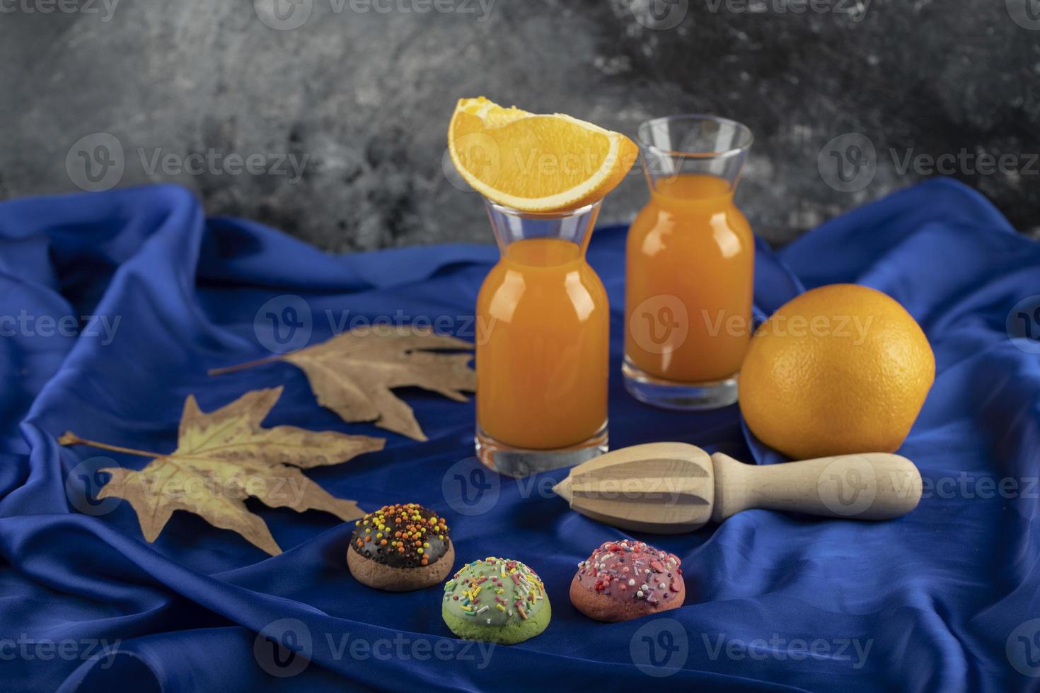 Two glass pitchers with delicious juice and sliced orange fruit photo