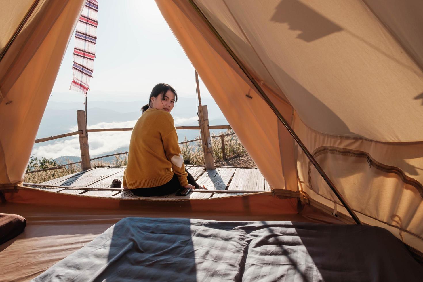 Woman sitting outside of a tent photo