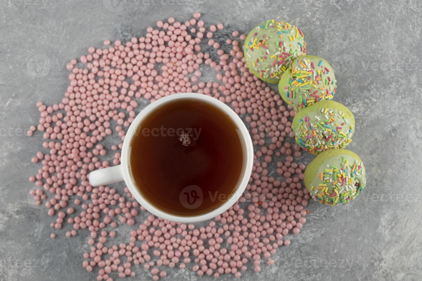 Green sweet doughnuts with a cup of tea photo