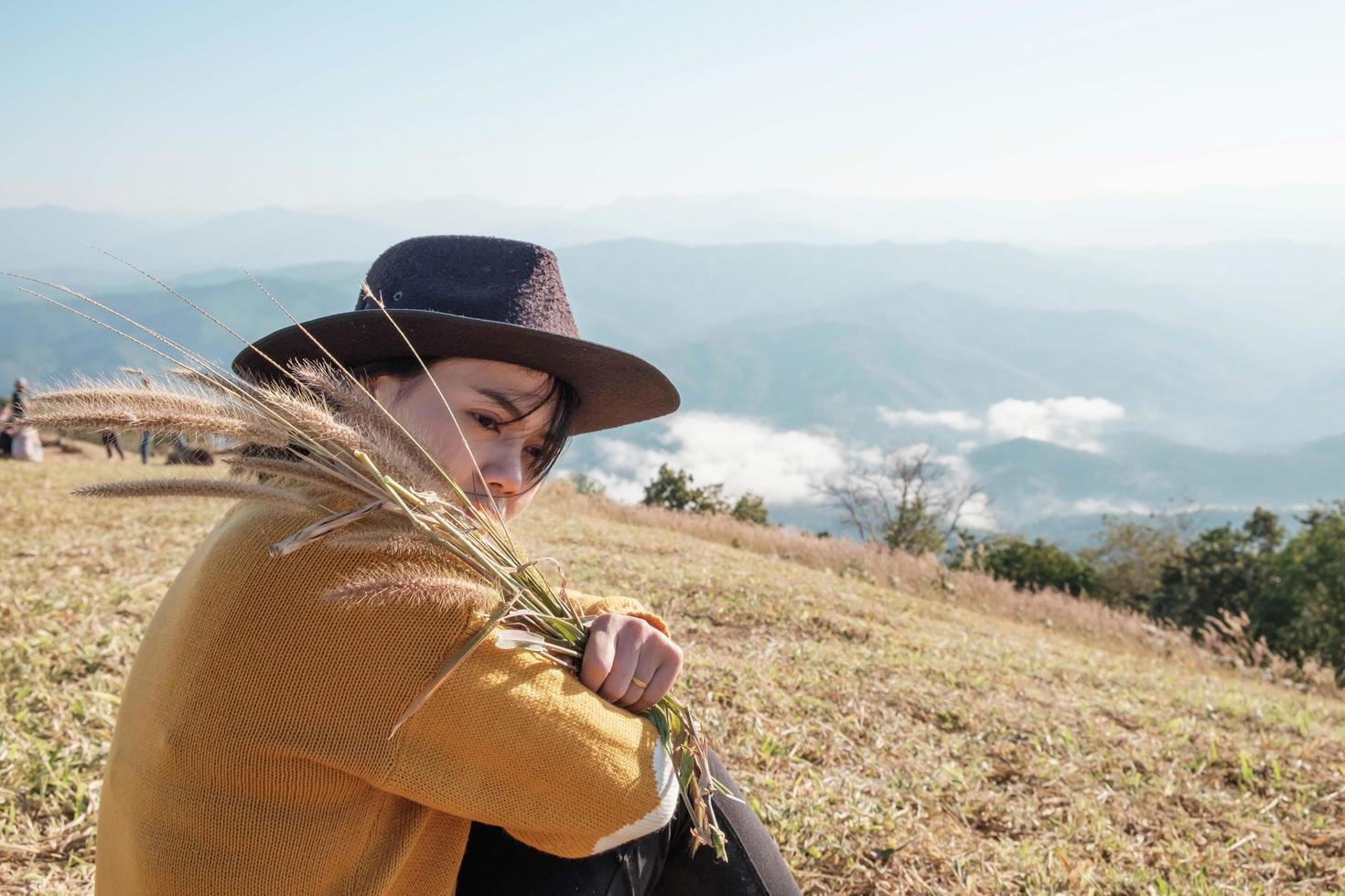 Woman holding rice while sitting photo