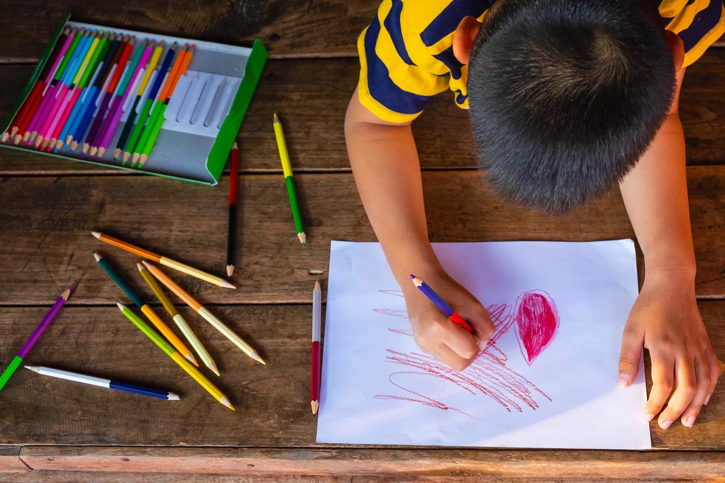 Boy coloring with coloring pencils photo