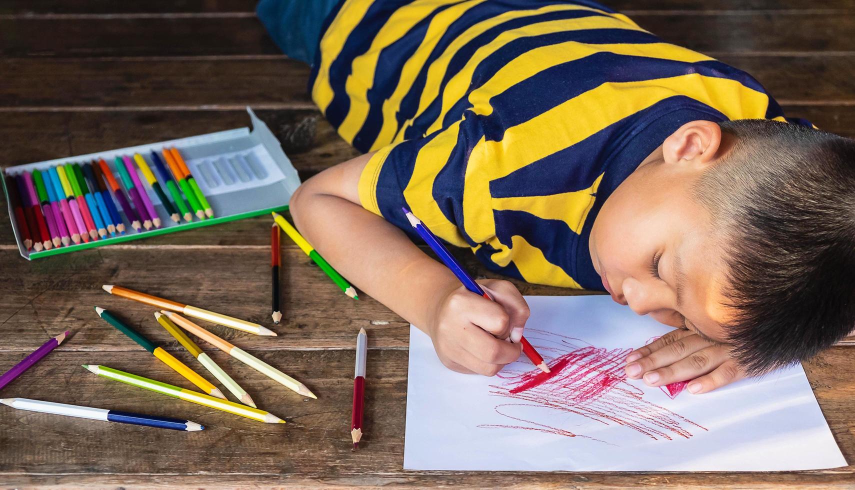 Boy coloring on paper photo