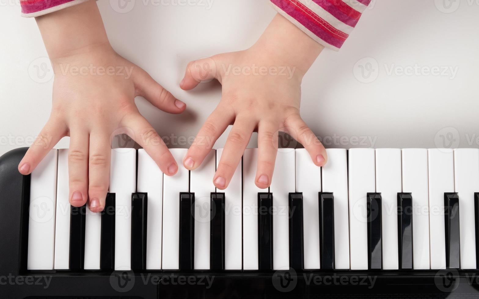 Kid playing piano photo