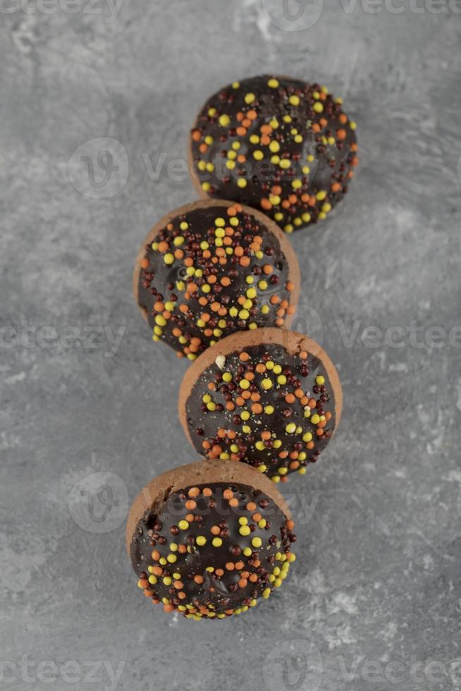 Chocolate sweet doughnuts with sprinkles photo