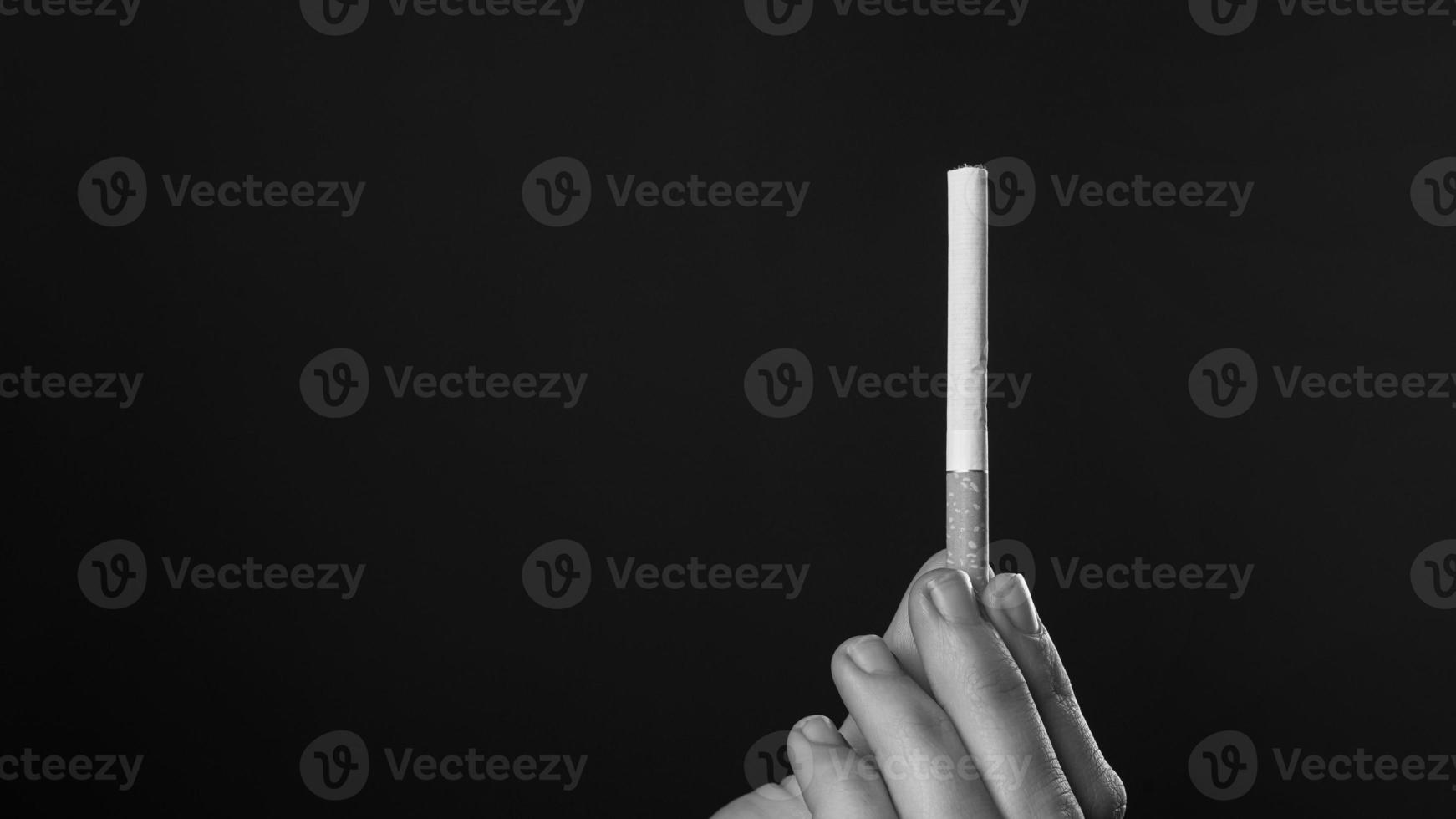 Black and white of a hand holding a cigarette photo