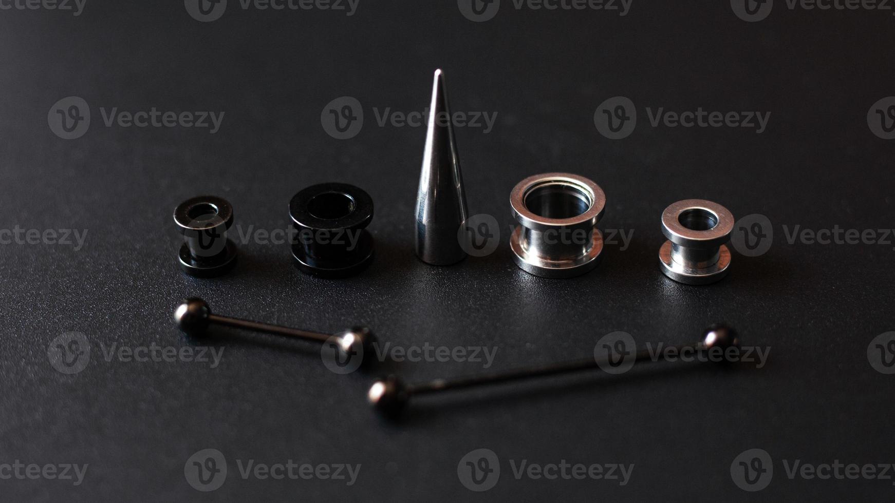 Piercing tools on a black background photo