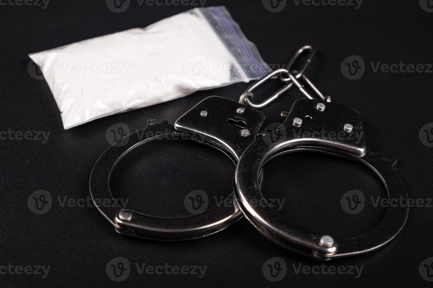 Handcuffs and white powder photo