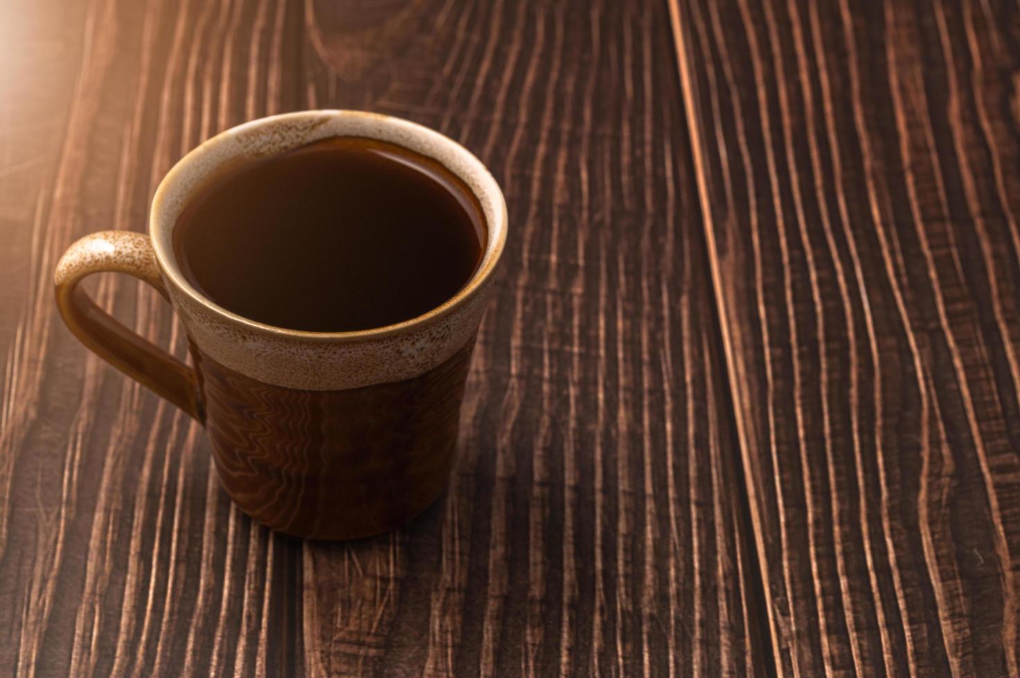 A coffee cup on a wooden table photo