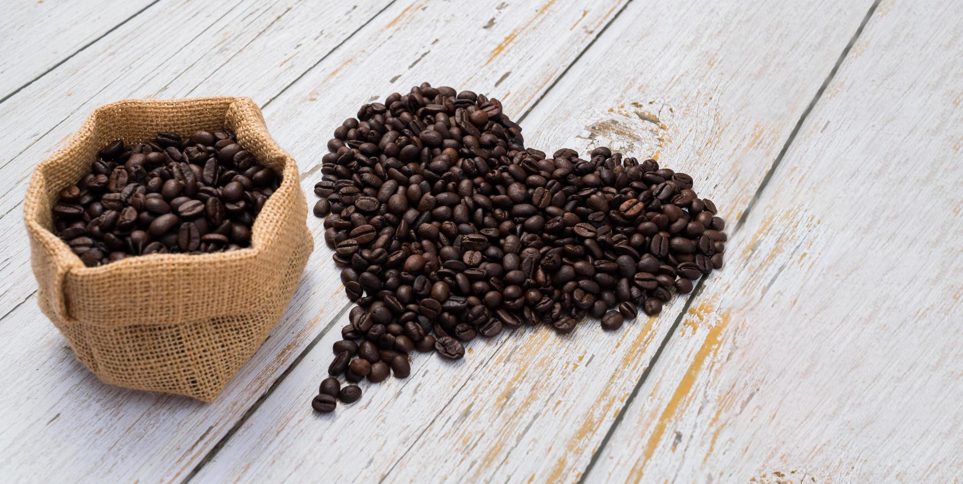 Coffee beans arranged in a heart shape, love drinking coffee concept photo