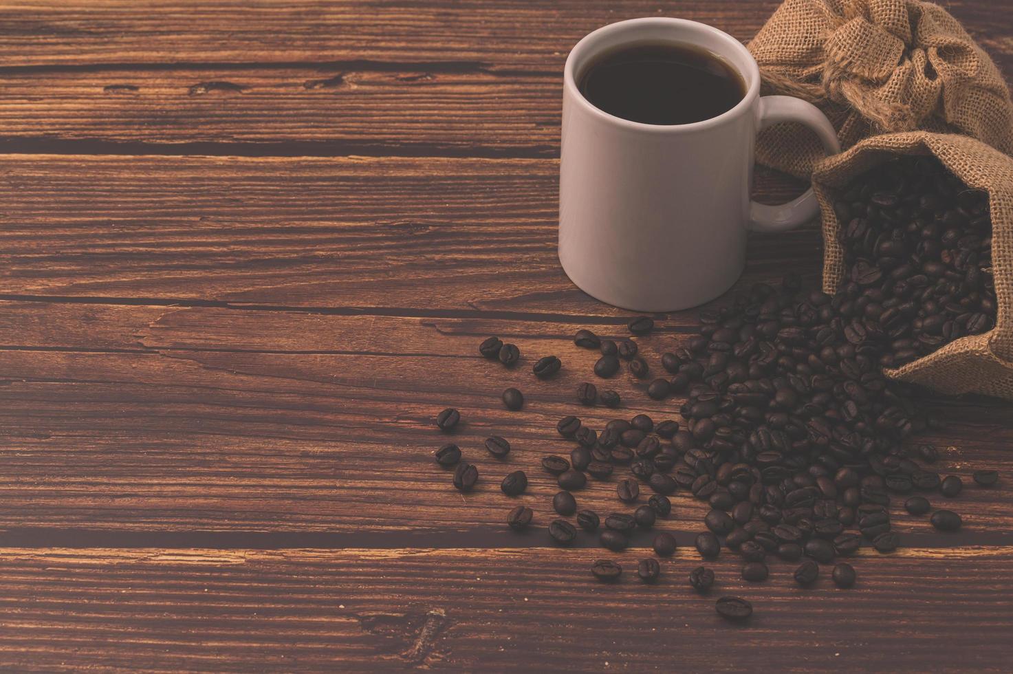 Coffee beans on a wooden table, love drinking coffee concept photo