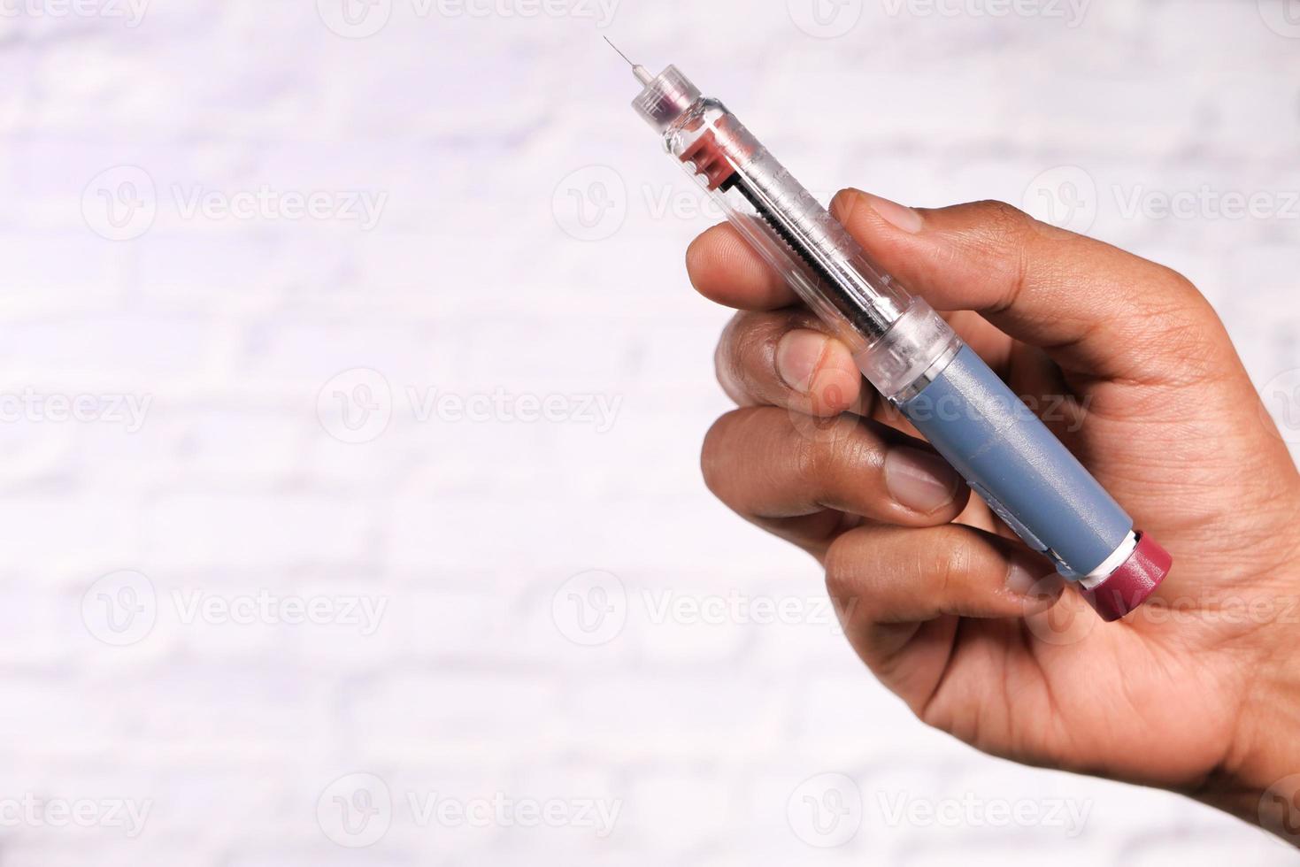 Hand holding an insulin pen photo