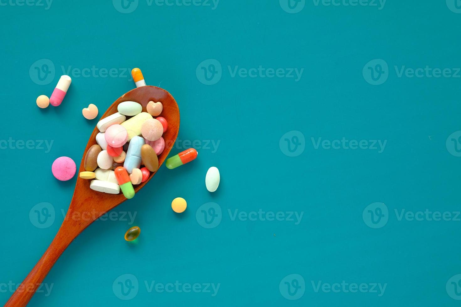 Close up of colorful pills on green background photo