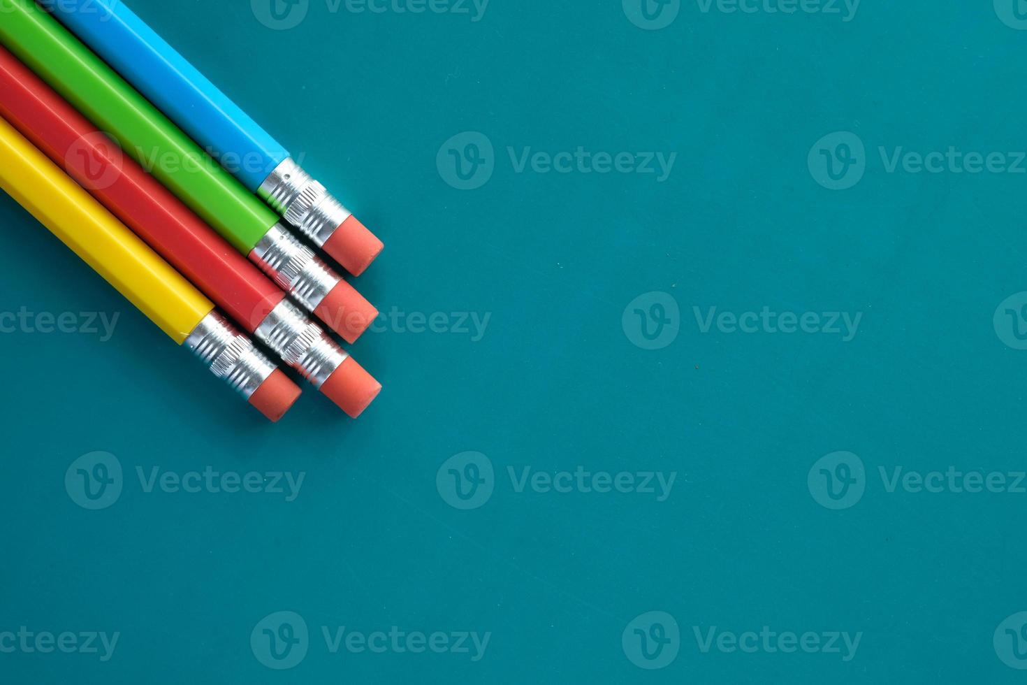 Colorful pencils on blue background photo