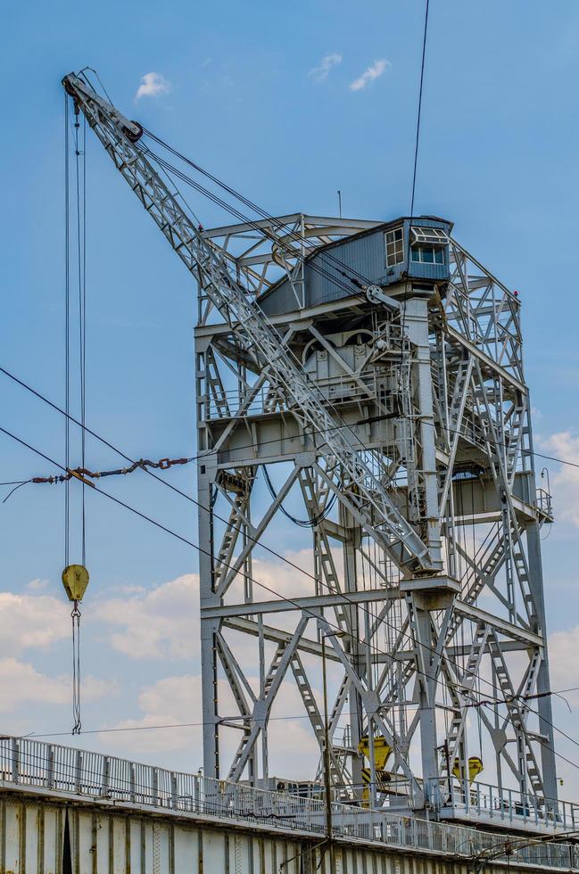 Bridge crane and hydroelectric plant on blue sky background photo