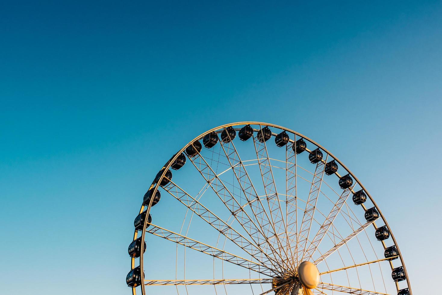 Ferris wheel against the blue sky photo