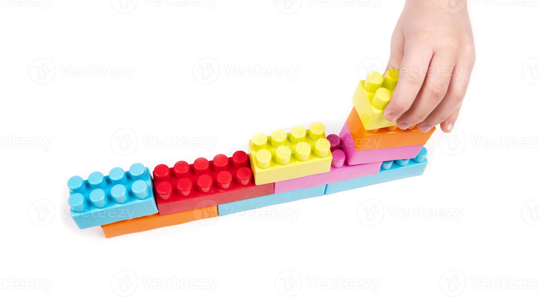 Kid playing with building blocks photo