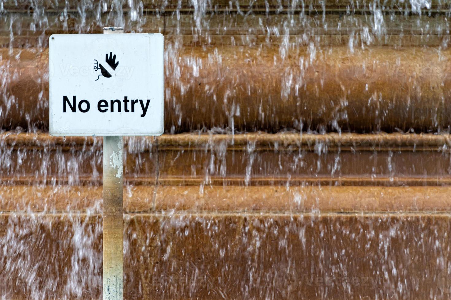 Sign prohibiting entry in the pool at the city fountain photo