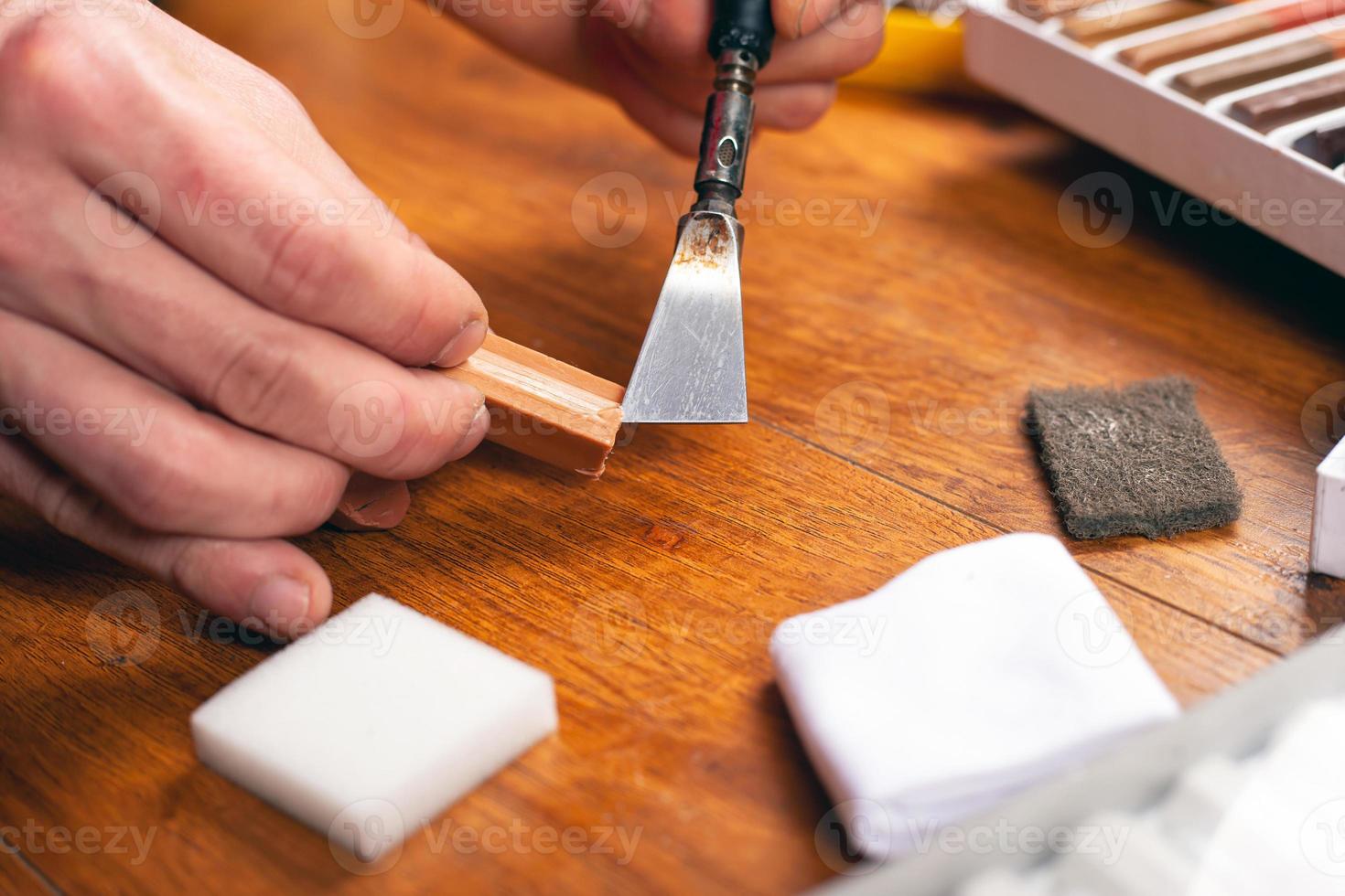 Person restoring a wood parquet photo