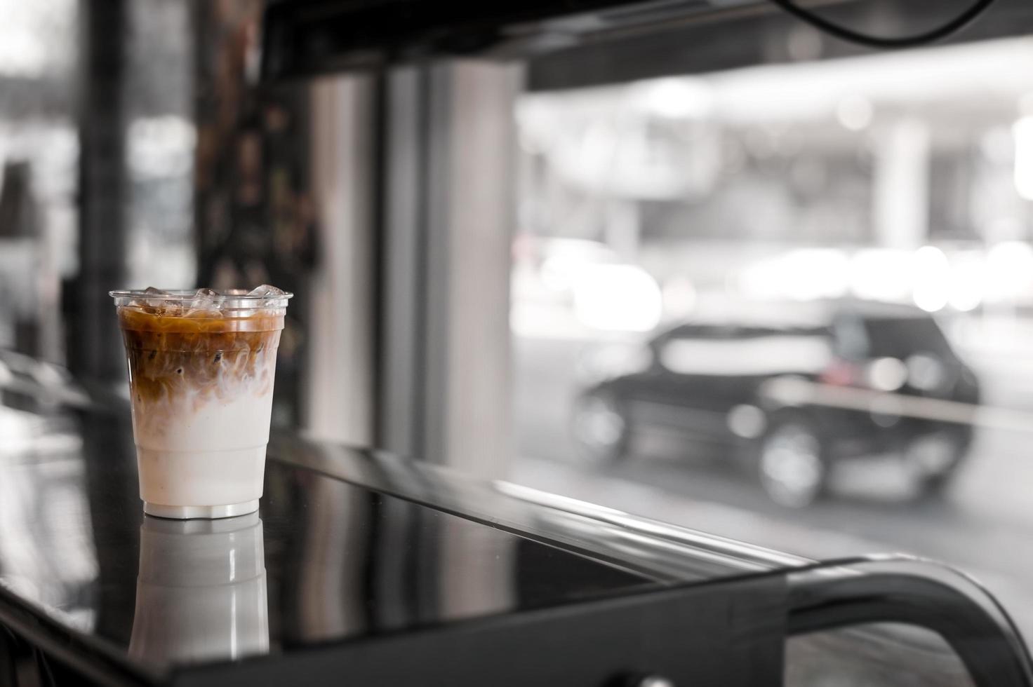 Glass of iced coffee with milk on the table photo