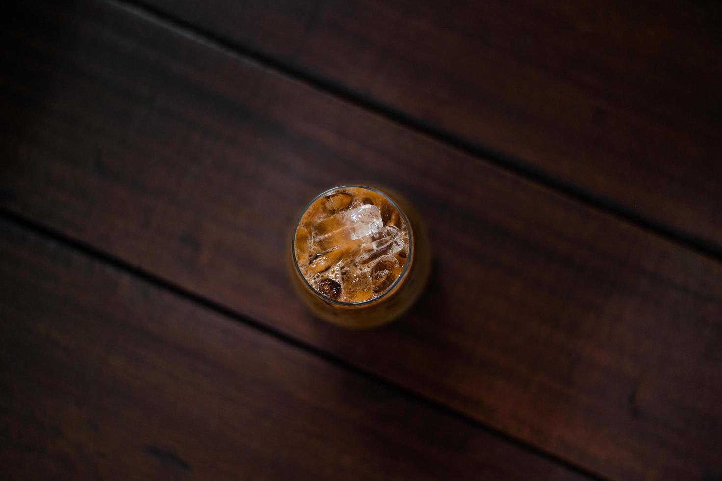 Glass of iced coffee with milk on the table photo