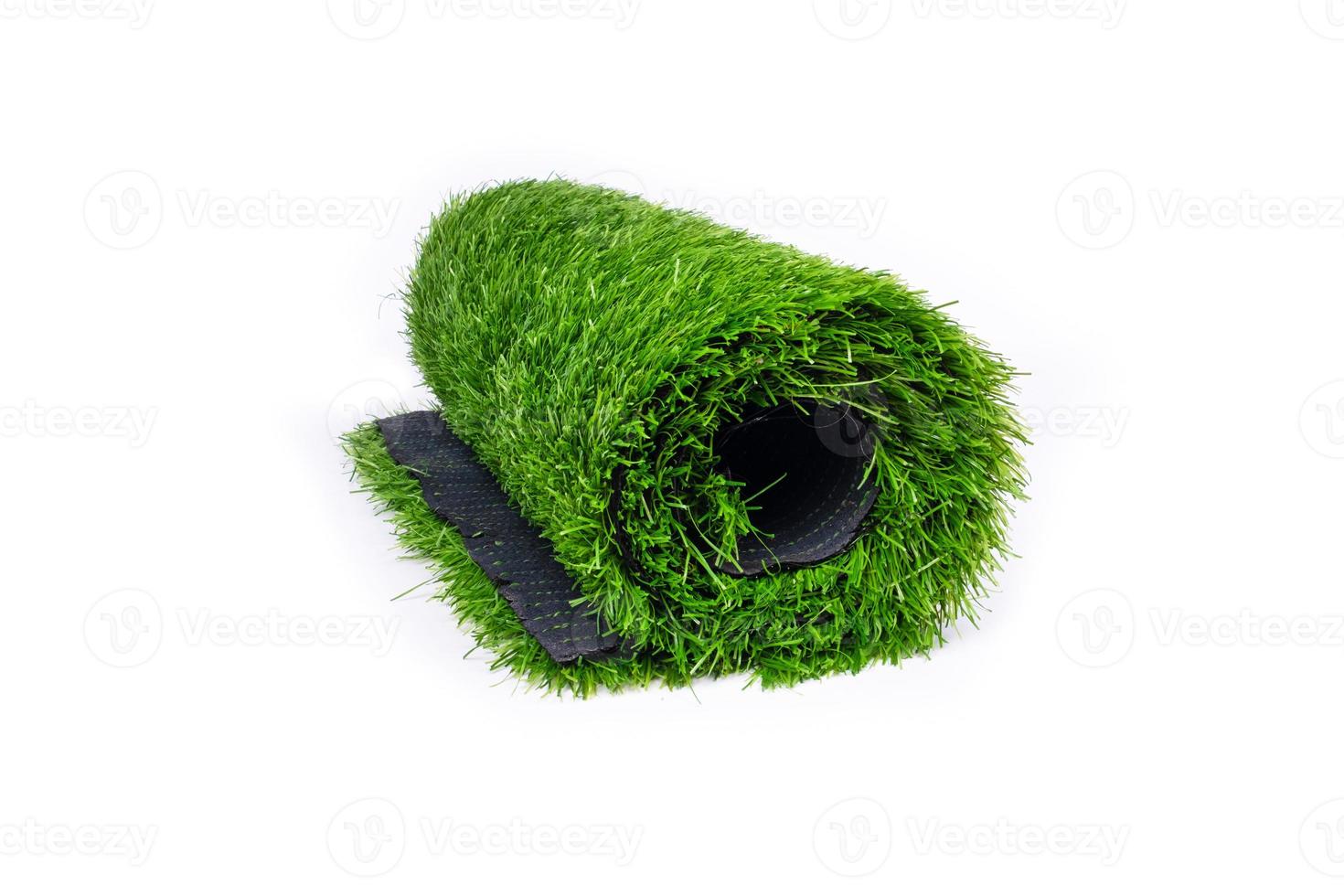 Roll of artificial grass isolated on white background. photo