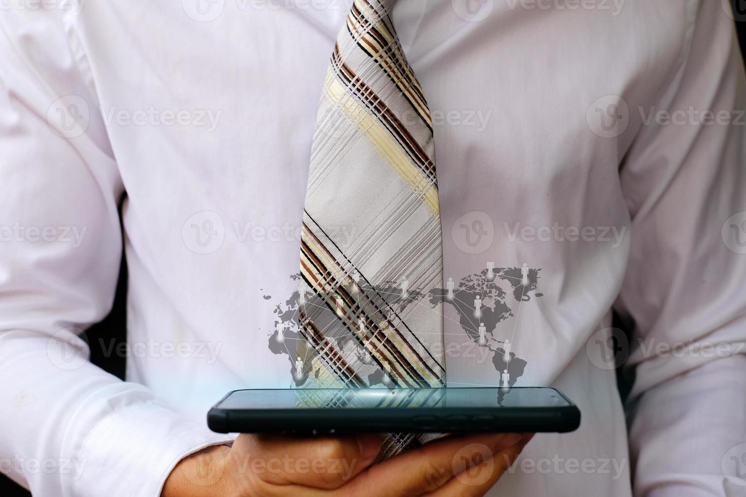 Businessman holding smartphone and technology network concepts photo