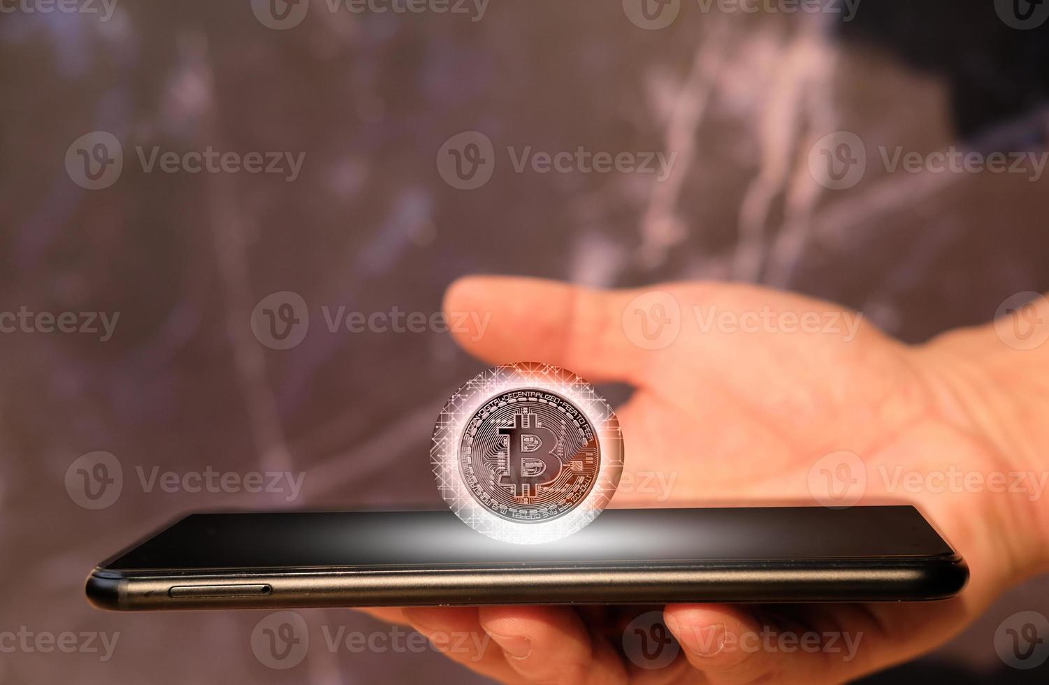 Bitcoin cryptocurrency coin and euro coin on smartphone, concept photo